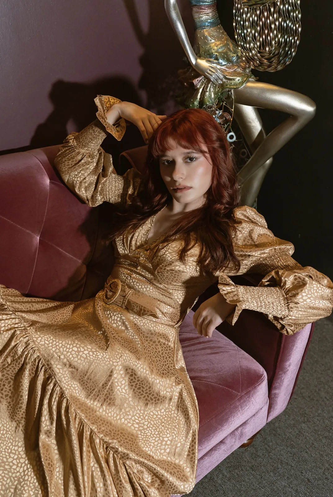 Editorial portrait of a woman in a gold dress photographed by LORENA