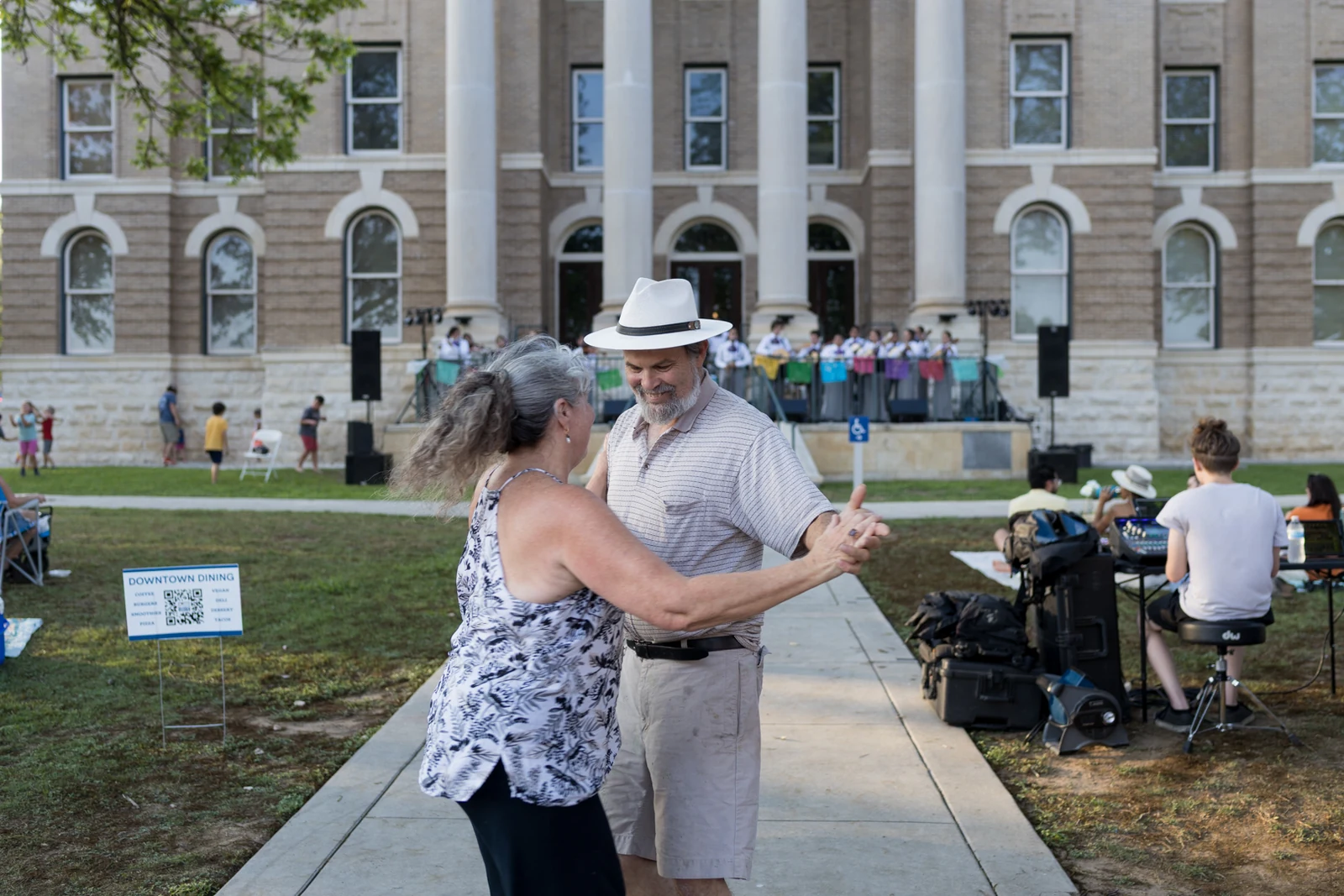 Couple dancing at an outdoor community event photographed by Anthony