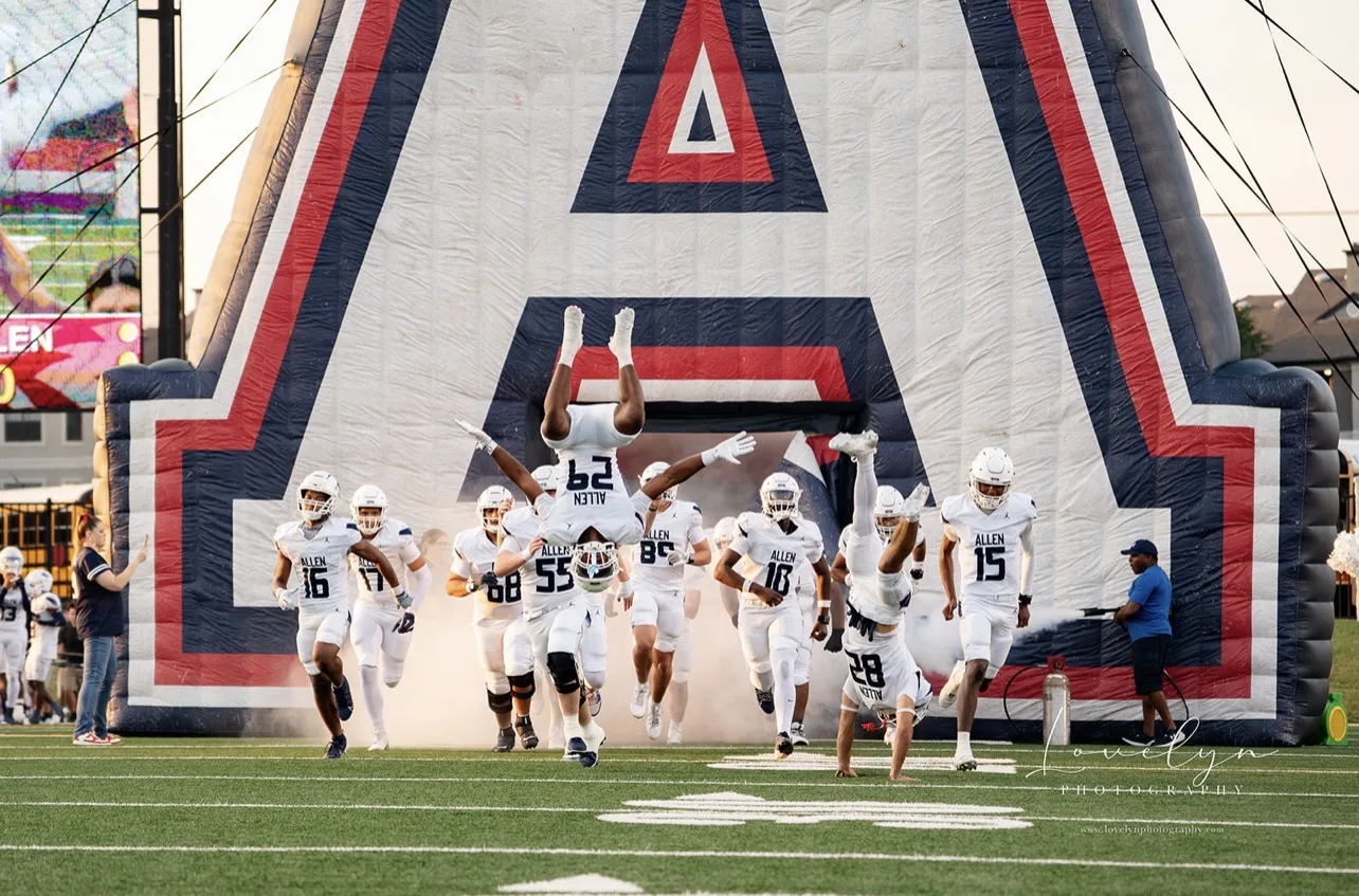 Football team entering the field before a game photographed by LORENA