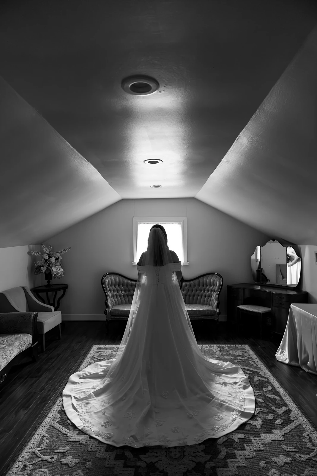 Black-and-white bridal portrait in a vintage room photographed by Anthony
