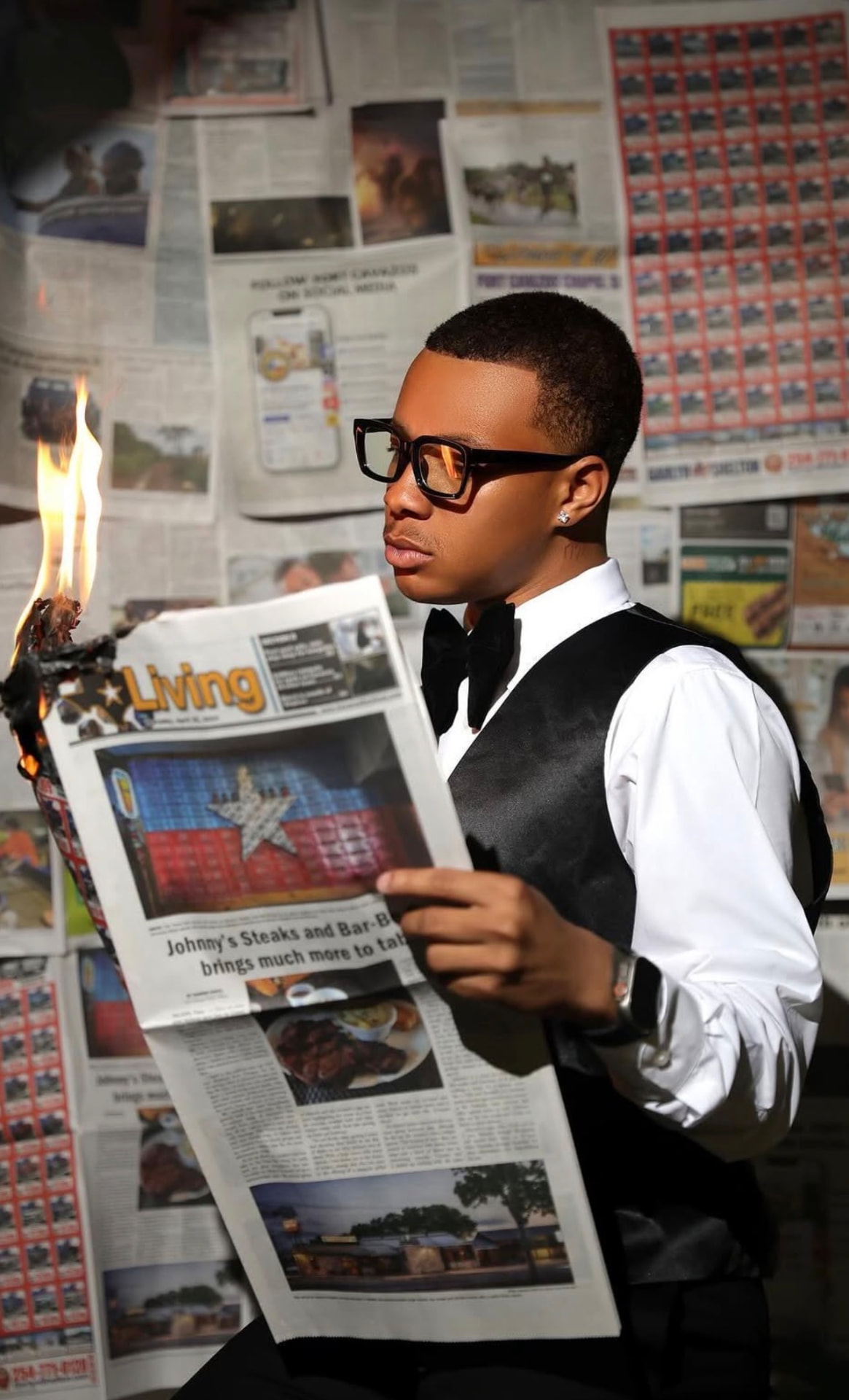 Creative concept portrait of a man reading a burning newspaper