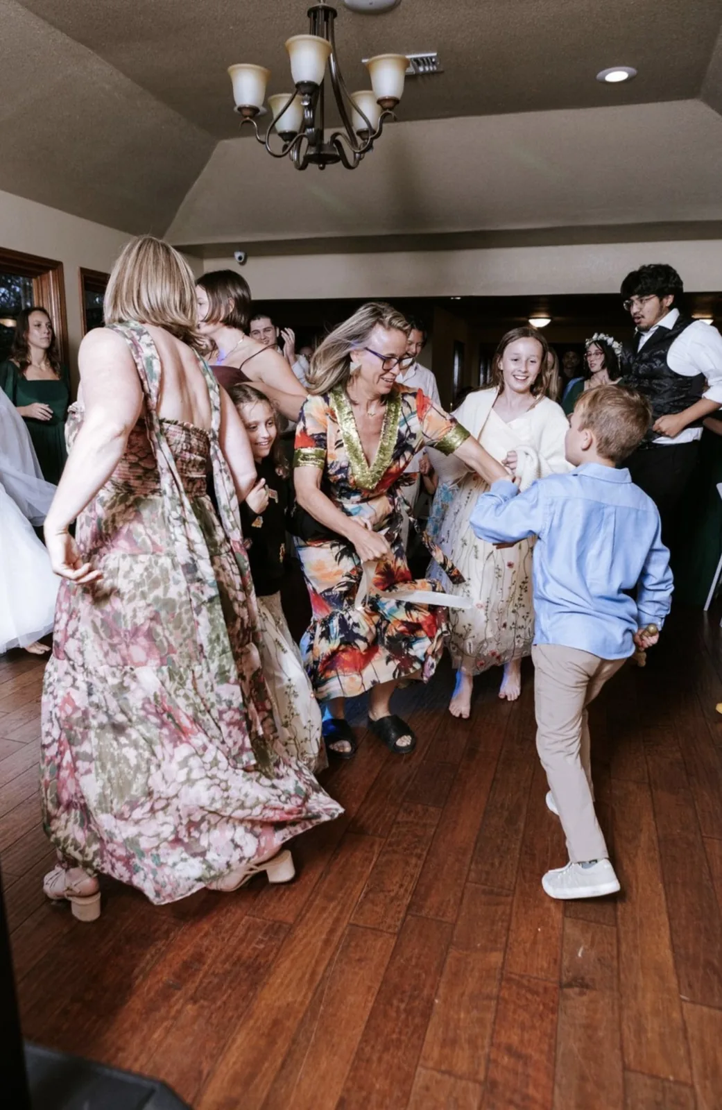 Wedding guests dancing together in a candid reception moment