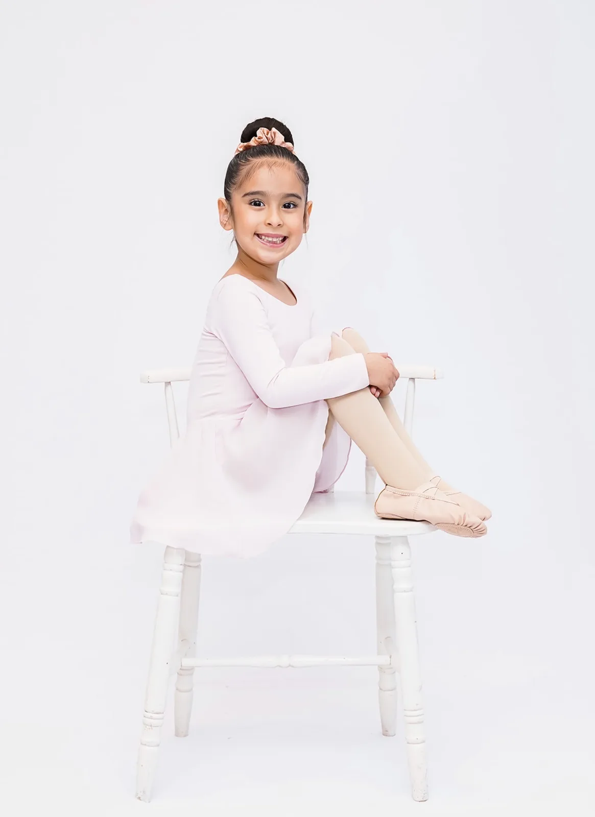 Young dancer seated in a studio portrait photographed by LORENA