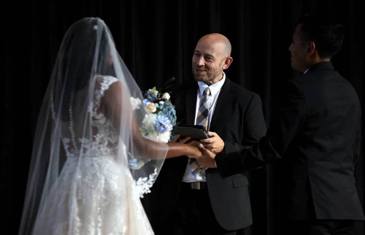 Wedding ceremony moment as the officiant leads the couple through their vows