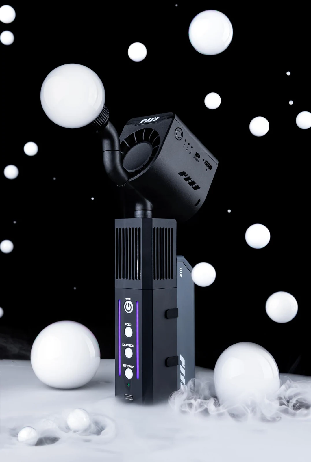 Studio product photograph of a compact fog machine surrounded by white spheres and mist