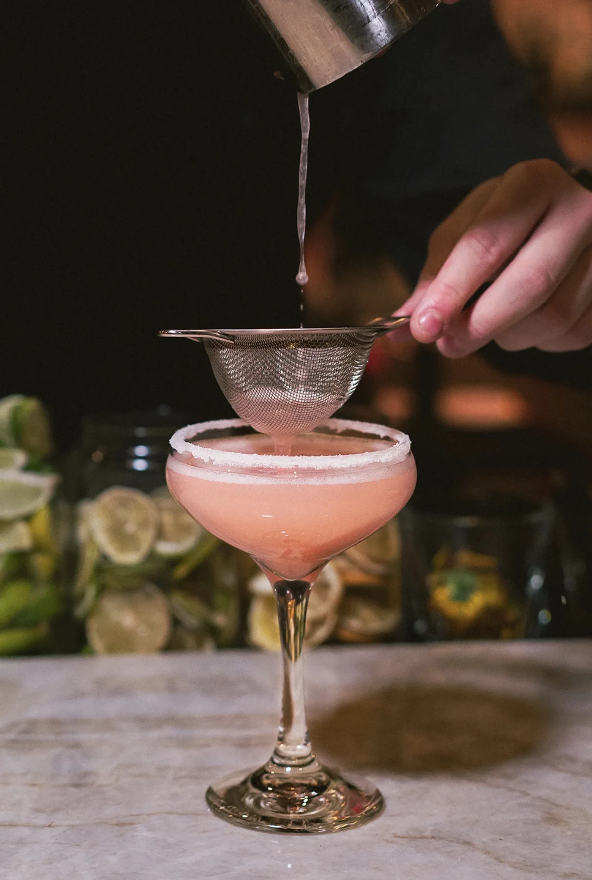Hospitality photograph of a pink cocktail being prepared by LORENA