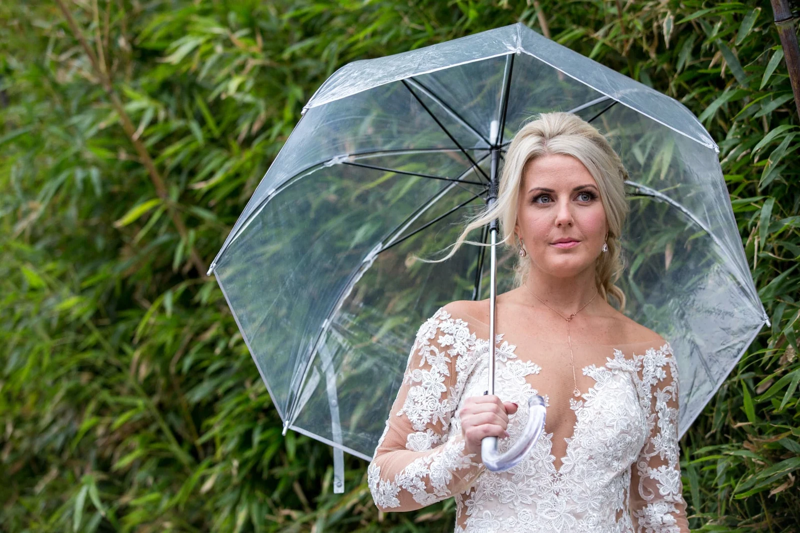Outdoor bridal portrait with a clear umbrella photographed by Anthony