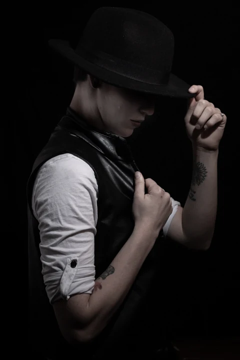 Dramatic studio portrait with a wide-brimmed hat photographed by Anthony