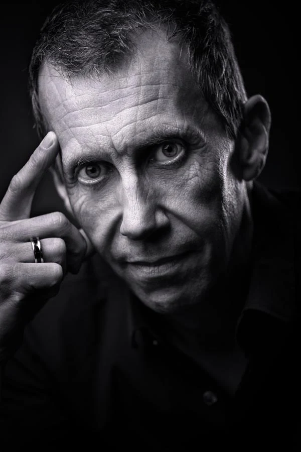 Black-and-white close-up portrait of a man photographed by Marcin