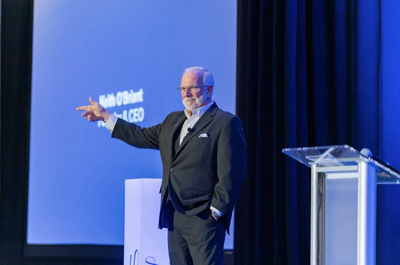 Corporate event speaker presenting onstage photographed by LORENA