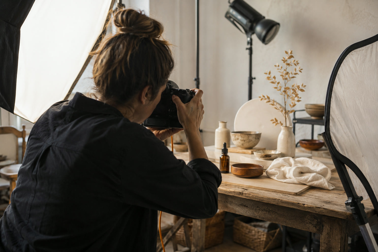 Photographer styling products in a studio for brand photography